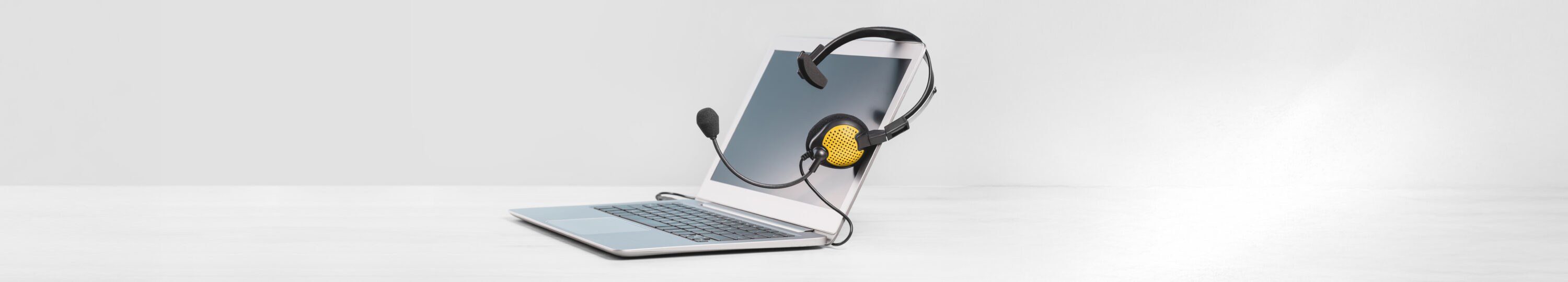 Laptop,With,Blank,Screen,With,Headphones,On,Desk,Blue,Background.